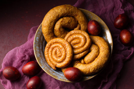 Homemade baked sausage with colored eggs. easter still life
