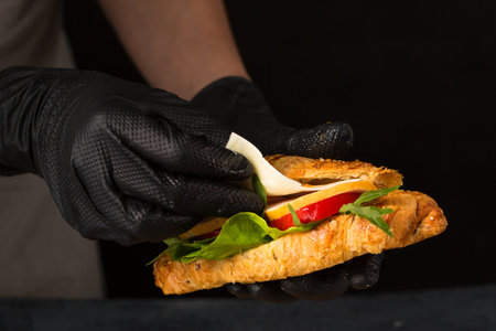 The chef prepares the croissant with the filling