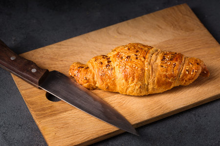 The chef prepares the croissant with the fillingの写真素材
