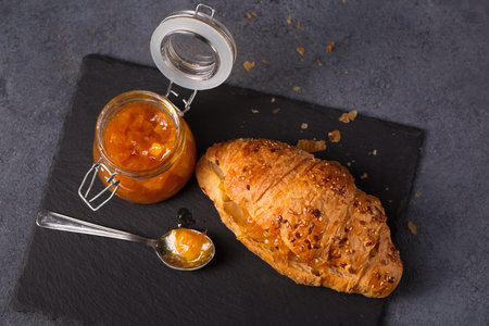 Ruddy, crunchy croissant with homemade orange jam