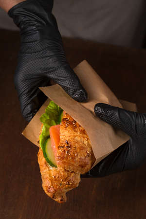 The chef prepares the croissant with the fillingの写真素材