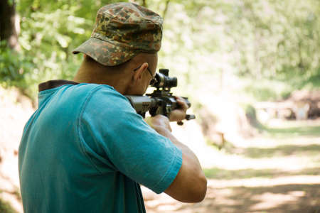 A Ukrainian civilian man is training to shoot an machine gun Ar-15 during Ukraine's war with Russiaの写真素材