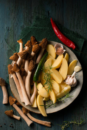 Morel forest mushrooms with raw potatoes and spicy spices