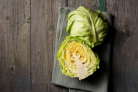 Young early cabbage cut in half on a dark backgroundの写真素材