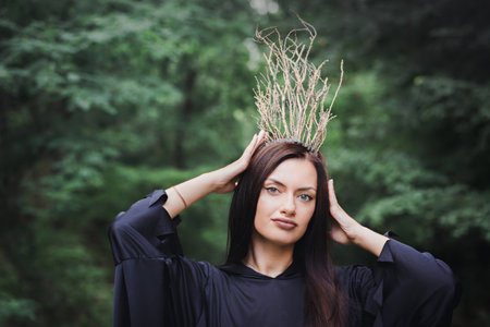 A beautiful young fairy in a crown of branches. Halloween conceptの写真素材