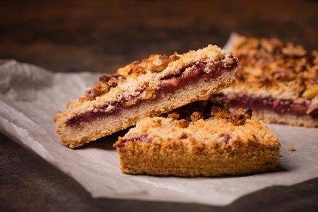 Grated cake with jam and nut filling on parchmentの写真素材