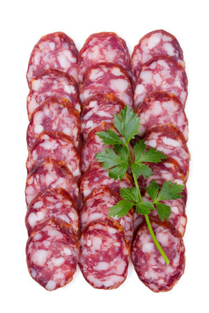 Raw smoked sausage cut into pieces, laid out in rows, isolated on a white backgroundの写真素材