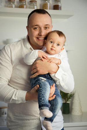 Portrait of a young loving father with a small child in his armsの写真素材