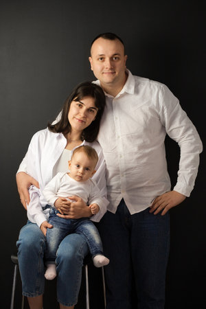 Portrait of young happy parents with a small childの写真素材