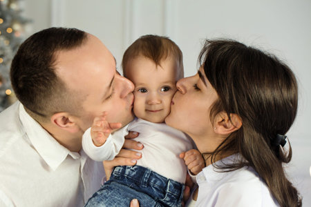 Portrait of young happy parents with a small child