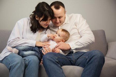 Portrait of young happy parents with a small childの写真素材