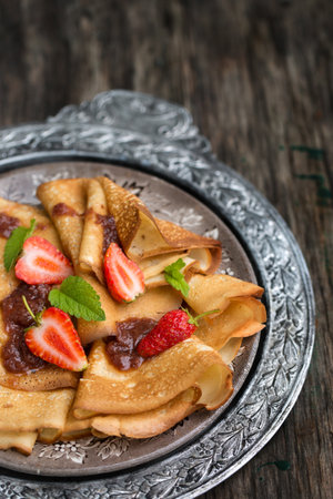 Delicious ruddy pancakes with strawberries and strawberry jam on a blue backgroundの写真素材