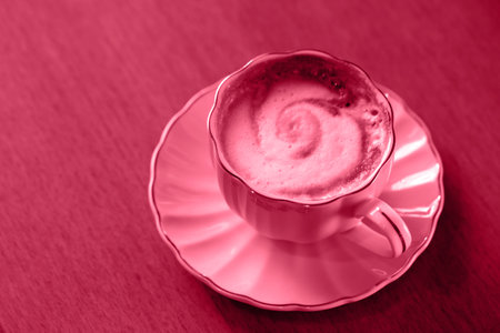 Cappuccino in pink cup on the tableの写真素材