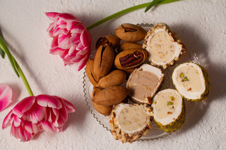 Still life of oriental sweets on a light background with pink tulipsの写真素材