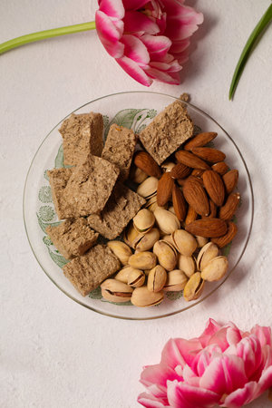 Still life of oriental sweets on a light background with pink tulipsの写真素材