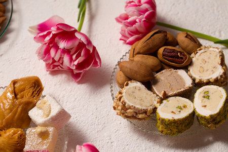 Still life of oriental sweets on a light background with pink tulipsの写真素材