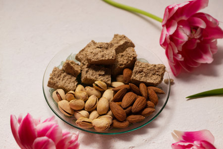 Still life of oriental sweets on a light background with pink tulipsの写真素材