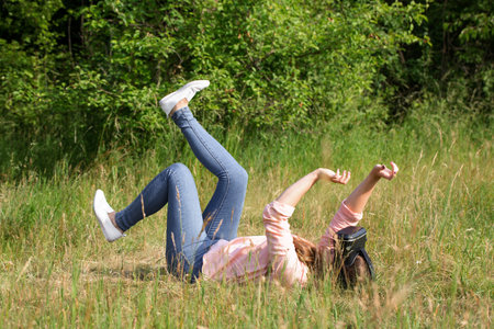 Young beautiful woman wearing virtual reality glasses having fun outdoorsの写真素材