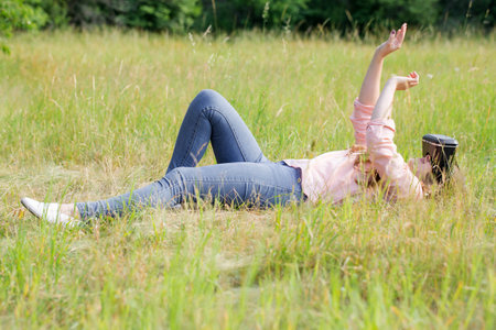 Young beautiful woman wearing virtual reality glasses having fun outdoorsの写真素材