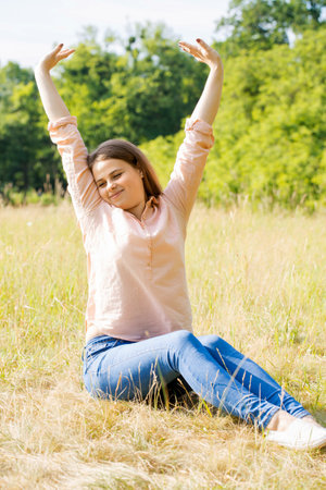 Portrait of a happy young girl in the park on a sunny dayの写真素材