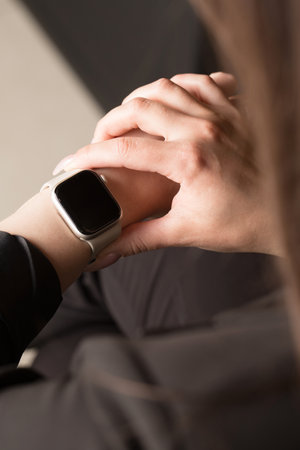 Young office worker looking at smart watch, hands close-upの写真素材