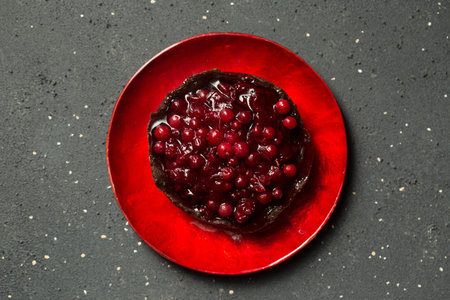 chocolate dessert with lingonberry jam on a dark background, top viewの写真素材