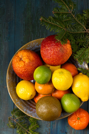 A variety of colorful citrus fruits on the bowl, rustic still lifeの写真素材