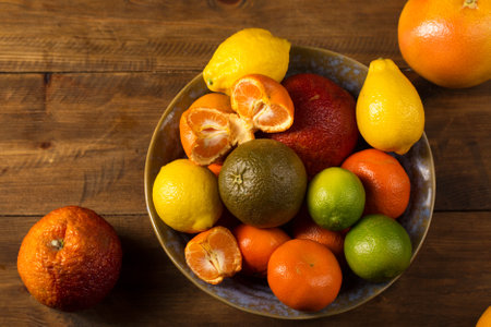 A variety of colorful citrus fruits on the bowl, rustic still lifeの写真素材