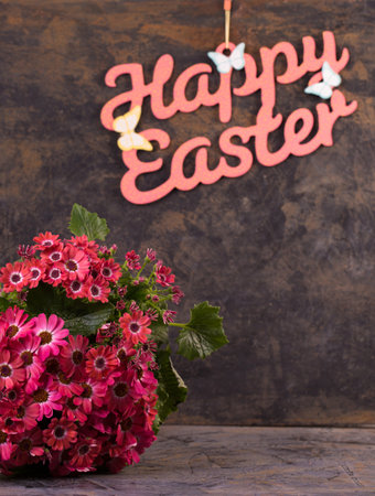 A bouquet of pink spring flowers on a metallic background with an inscriptionの写真素材