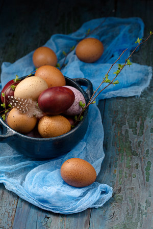 Still life with eggs in a blue bowl on a wooden background, rustic styleの写真素材