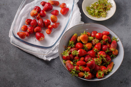 Juicy ripe strawberries in a large gray bowl on a gray backgroundの写真素材