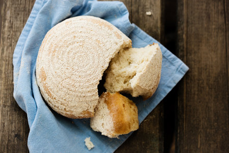A round loaf of bread on a blue napkinの写真素材
