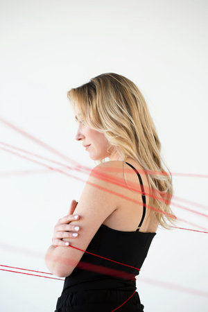 An adult woman with red threads. The concept of hopelessness