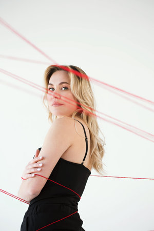 An adult woman with red threads. The concept of hopelessness