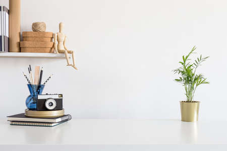 Creative workspace with camera, stationery and copy space on white tableの写真素材
