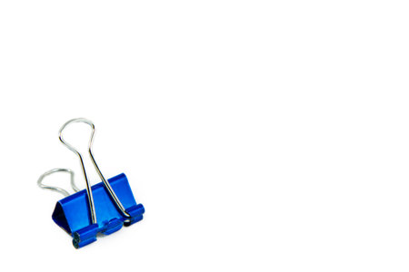 Blue Paper clip isolated on white background; The paper binder clip used for paper and documents. It...