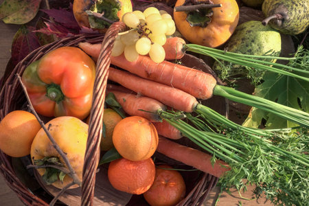 Harvested fruits and vegetables in a basket. Autumn harvest.
