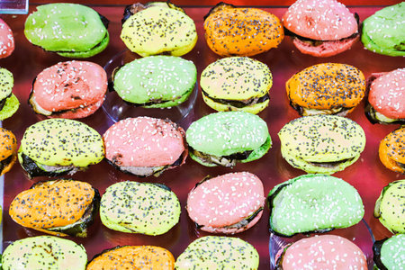 Colorful hamburgers on display at street food market, Thailand.