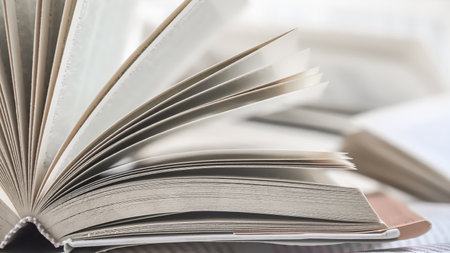 Open book on table in room, closeup. Education and reading conceptの写真素材