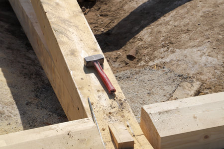 Hammer and nails on a construction site, closeup of photo