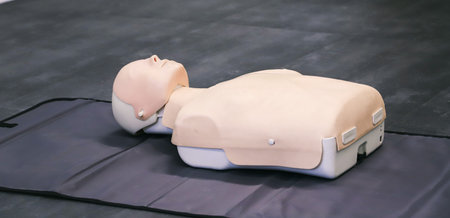 CPR training dummy lying on first aid bed in a hospital.