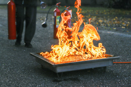 Fireman extinguishing a fire in the street. Firefighters extinguish a fire.