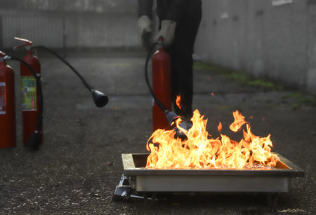 Firefighters extinguish a fire on the street. Firefighters extinguish a fire.の写真素材
