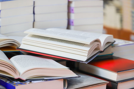 Stack of books on the table in library. Selective focus.の写真素材