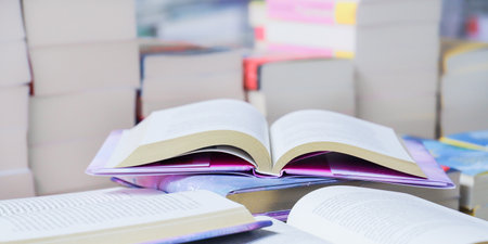 Open book, hardback books on table in library. Back to school. Copy space.の写真素材