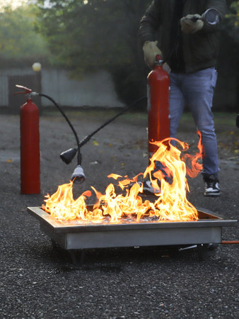 Fire extinguisher in the fire. Firefighters extinguish a fire.