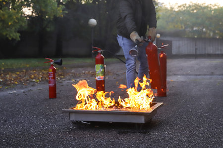 Firefighters extinguish a fire on the street in the autumn.の写真素材