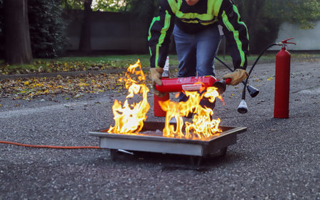 Firefighter extinguishing a fire in a residential area during a fire drill