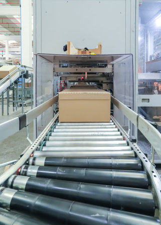 Conveyor belt with cardboard boxes in a production line in a factory