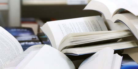 Books on shelf in library, shallow depth of field, focus on foreground